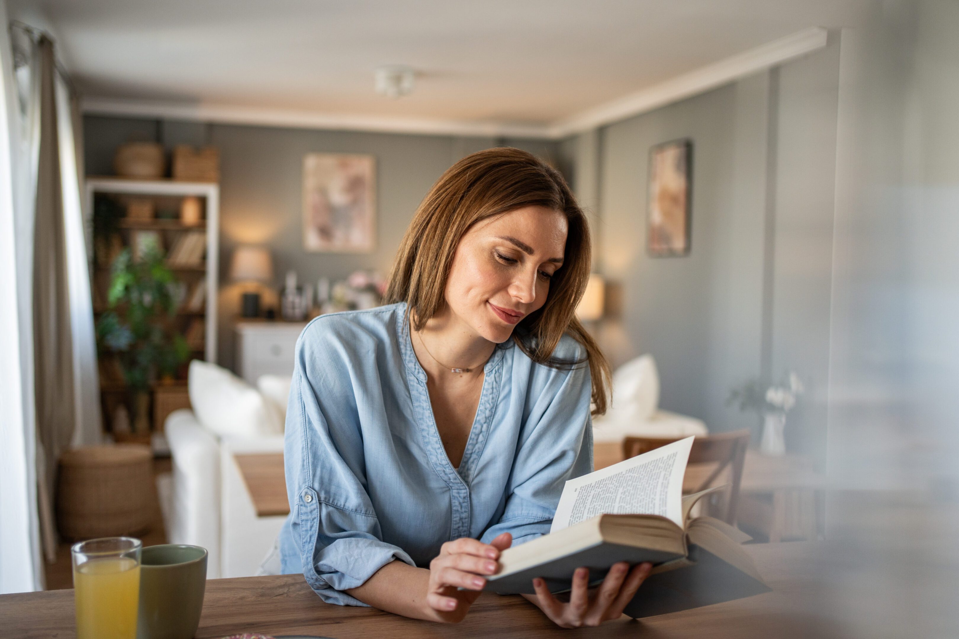 Relaxed woman enjoying a book indoors