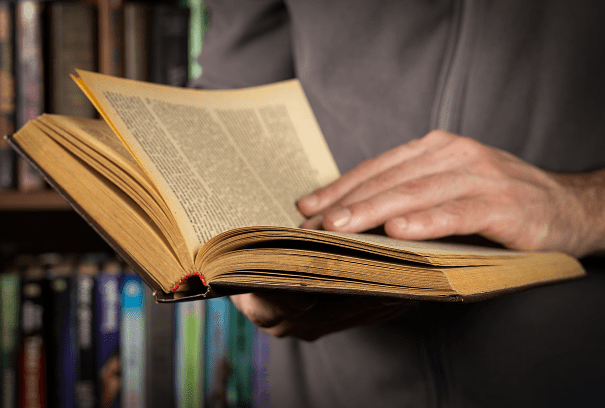 Person flipping pages of a book