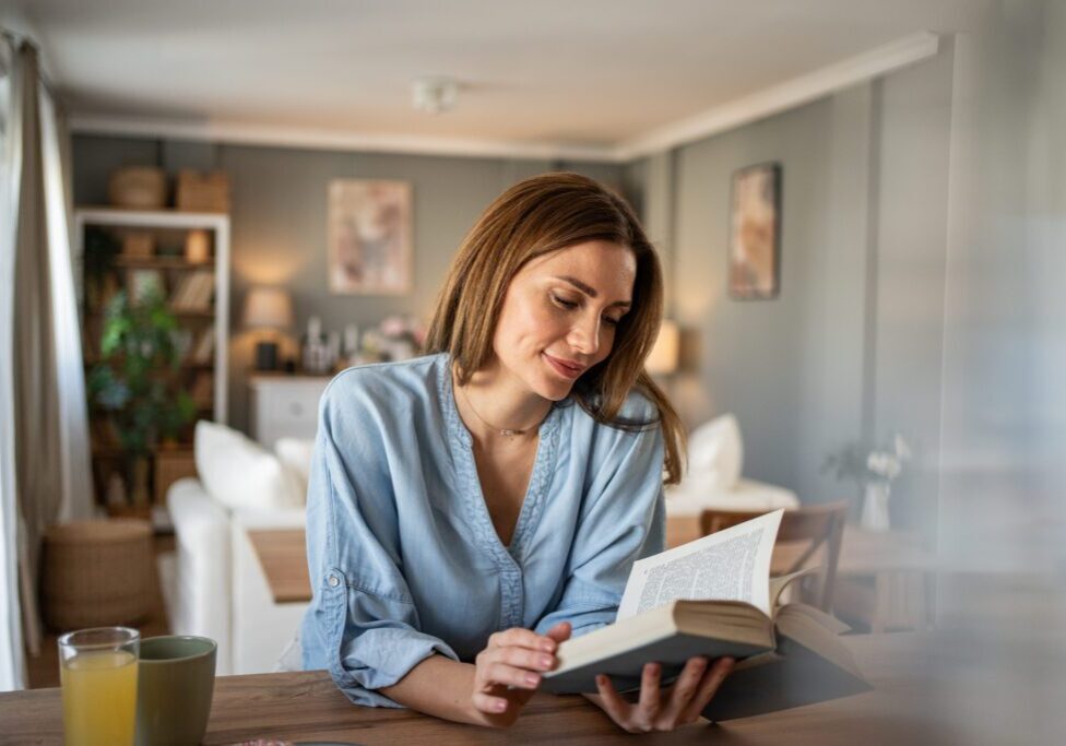 Relaxed woman enjoying a book indoors